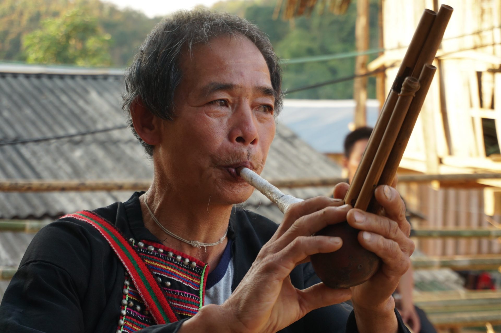 A Lahu man plays the mouth organ