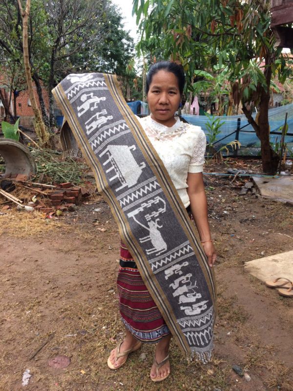Krieng Nge artisan holding textile in village