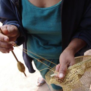 Kmhmu artisan making jungle vine piat bag Laos