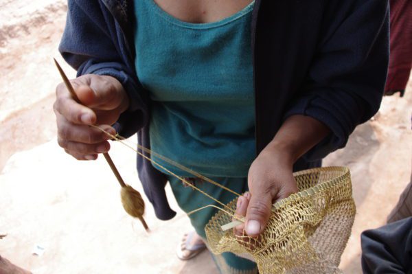 Kmhmu artisan making jungle vine piat bag Laos