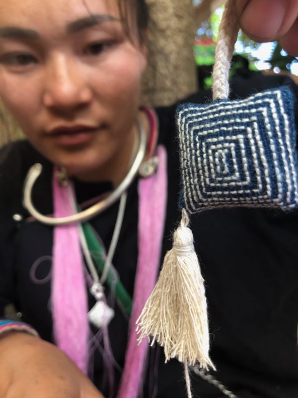 Lanten artisan holding embroidered ornament Laos